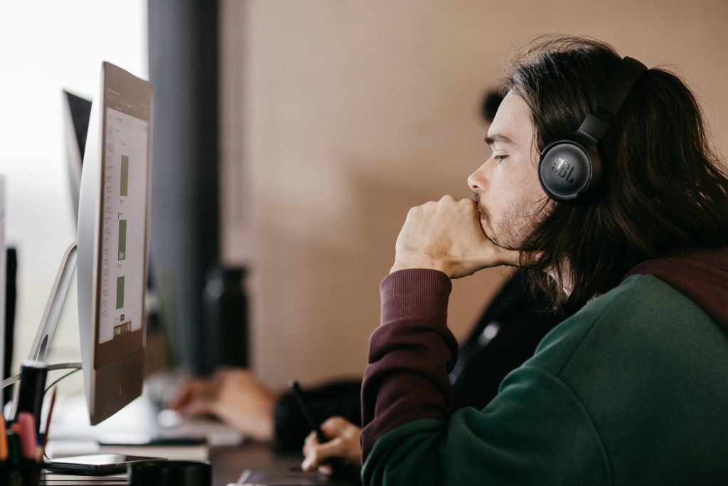 Man listening to something while on the computer